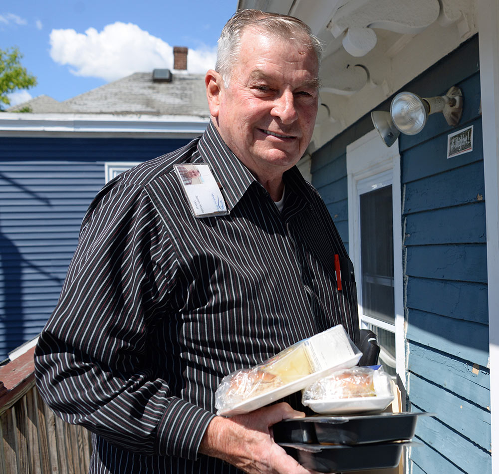 volunteer delivering meal